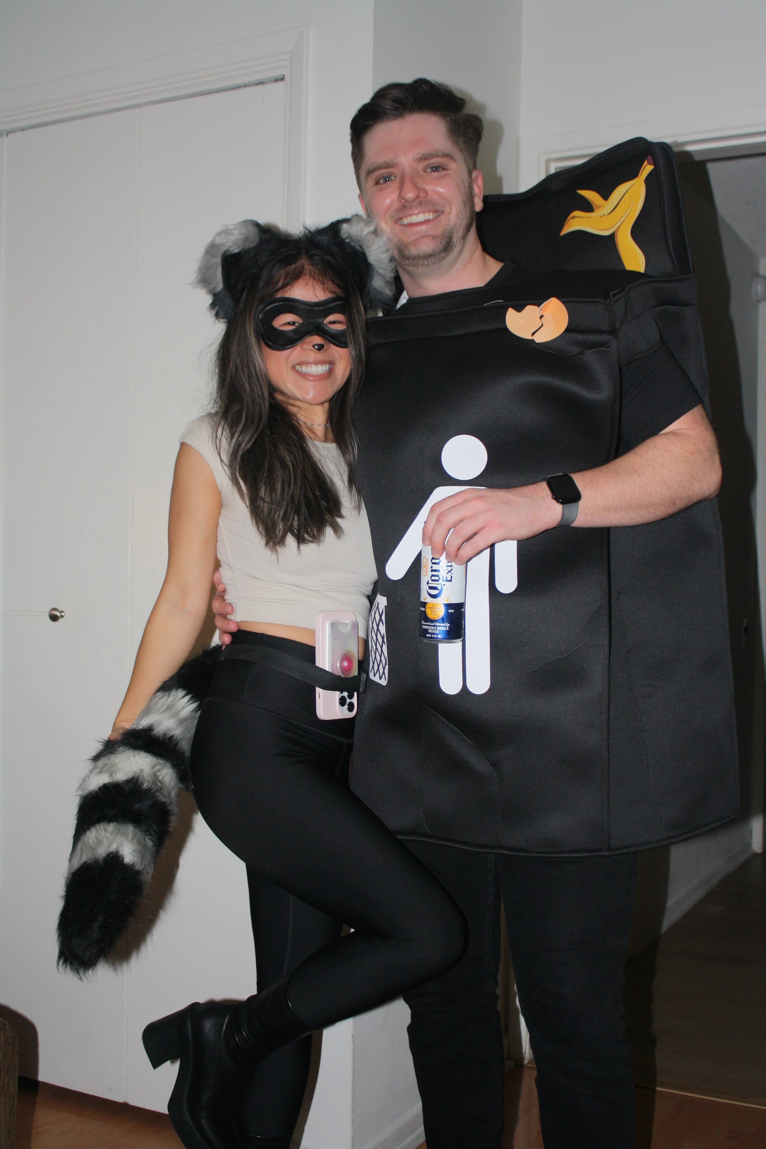 A couple dressed as a raccoon and trash can
